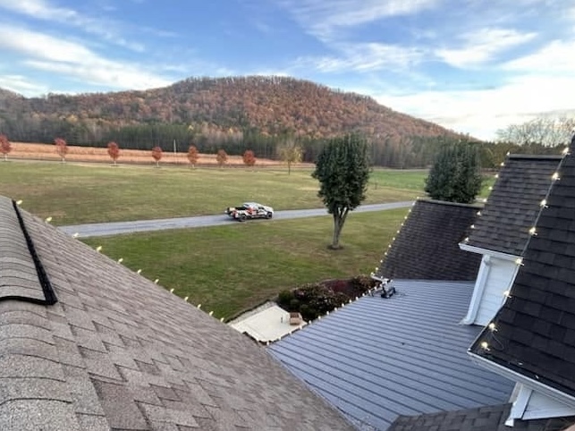 Residential Christmas light installation in progress along roofline