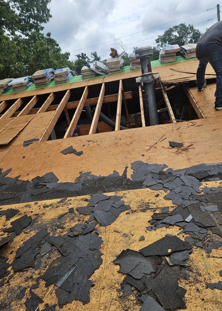 Roof tear-off with damaged decking exposed during East Brainerd roof replacement