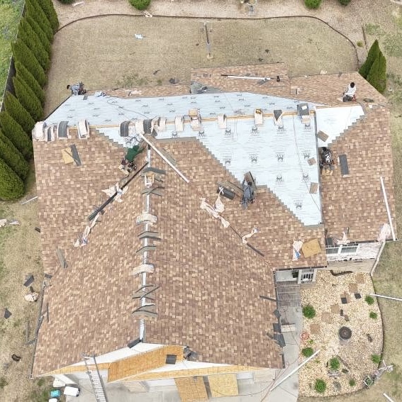Residential roof replacement in progress with underlayment installed