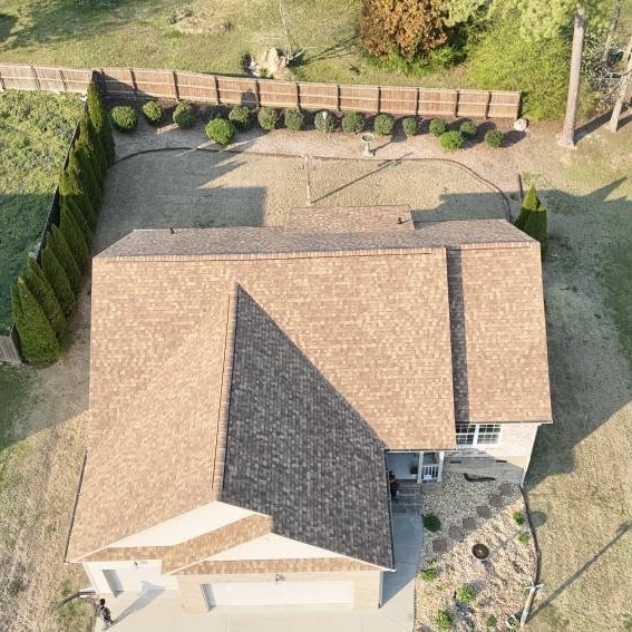 Completed residential asphalt shingle roof replacement aerial view