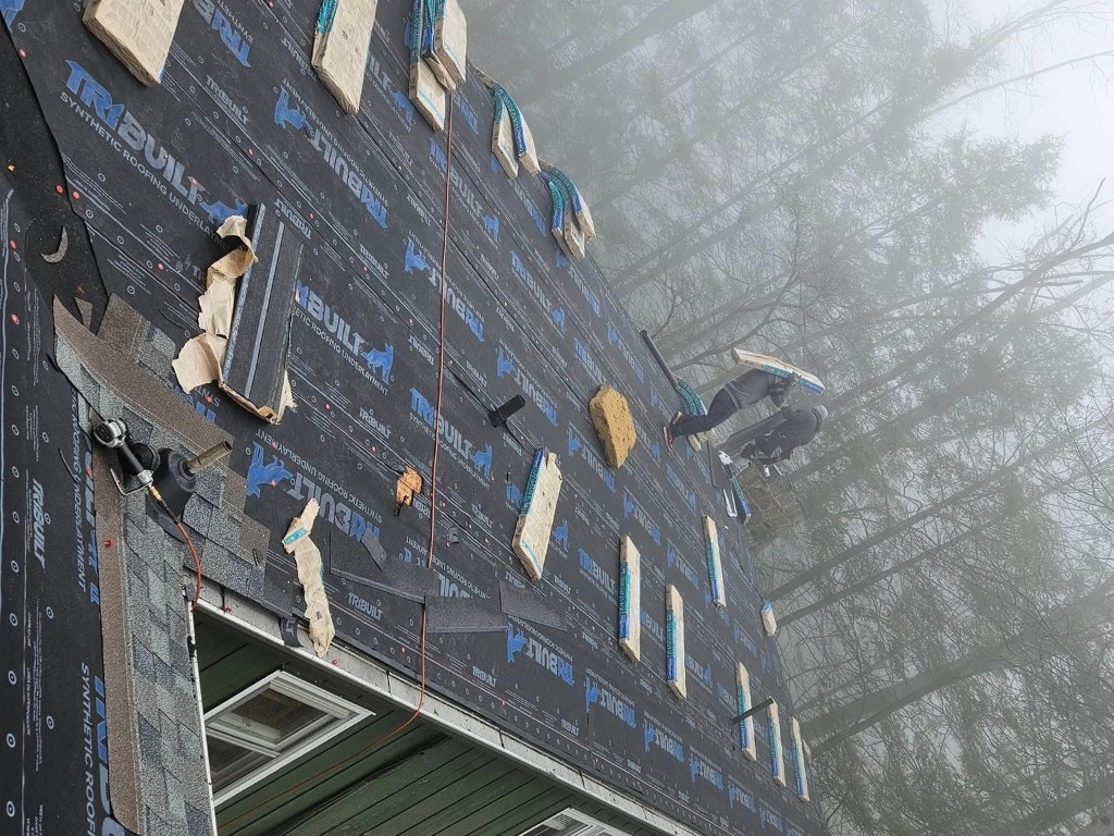 Synthetic underlayment and staged roofing materials during roof replacement